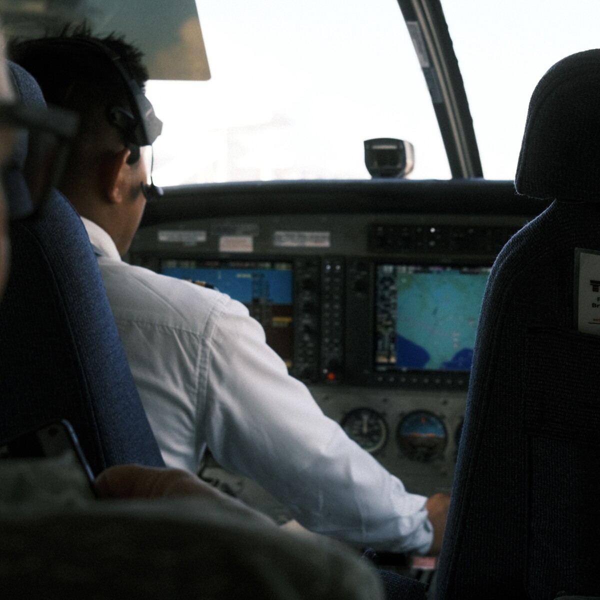 Photo of a pilot at the controls of a Cessna Caravan.