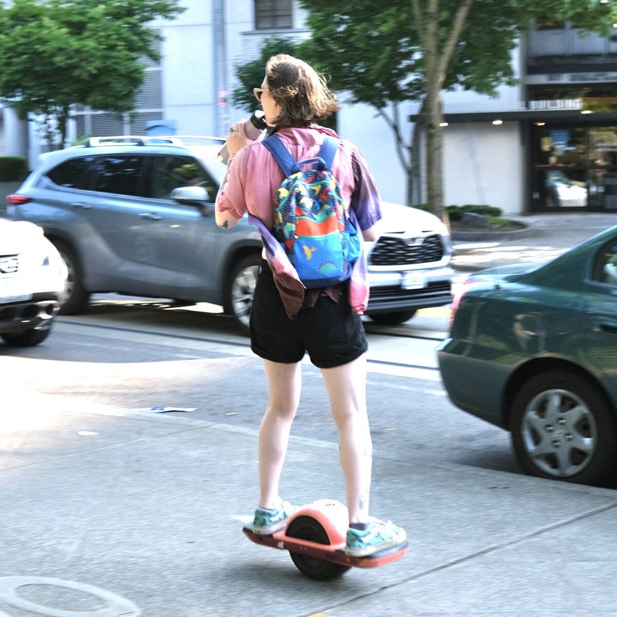 A person riding a One Wheel in the bike lane in Capitol Hill, Seattle.